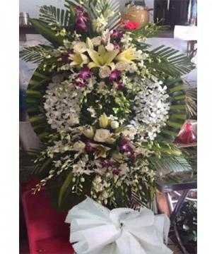 vòng hoa viếng đám tang được làm từ hoa lan trắng, hoa lan tím, hoa hồng và hoa lily. dịch vụ hoa tang lễ giao tận nhà