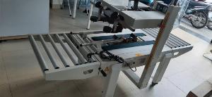 Máy dán băng keo thùng carton FXA6050, máy dán thùng mặt trên mặt dưới bán tự động